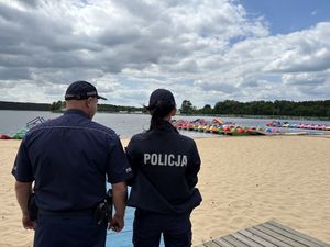 Policjanci rozmawiają z pracownikami wypożyczalni sprzętu wodnego